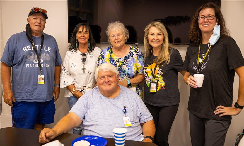 A group of bus drivers smiles